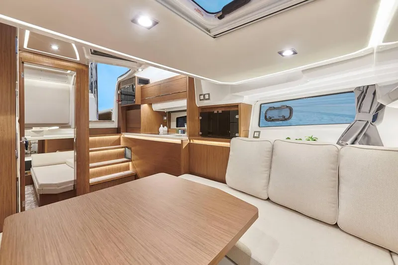 Slide: The Image of Manufacturer Provided Image: Modern interior of 2022 Jeanneau Leader 12.5 WA yacht with cozy seating and wooden finishes. - 5