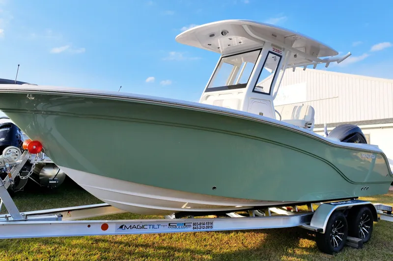 The Image of 2026 Sea Fox 228 Commander boat on trailer, displayed outdoors under blue sky. - 0