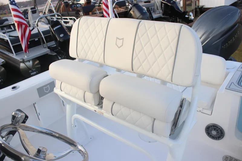 Slide: The Image of 2026 Sea Fox 228 Commander boat with white cushioned seating and steering wheel. - 12