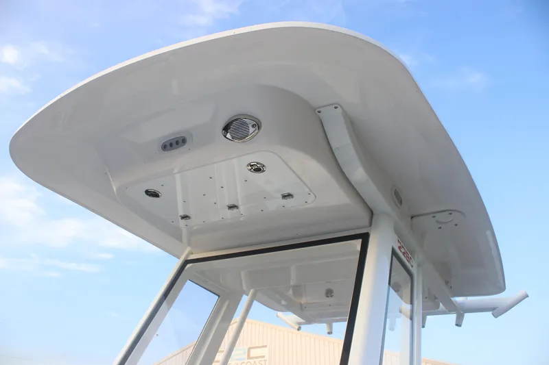 Slide: The Image of 2026 Sea Fox 228 Commander boat's T-top and console against blue sky. - 21
