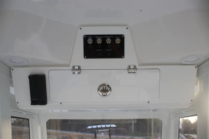Slide: The Image of 2026 Sea Fox 228 Commander interior dashboard with control panel and storage compartment. - 23