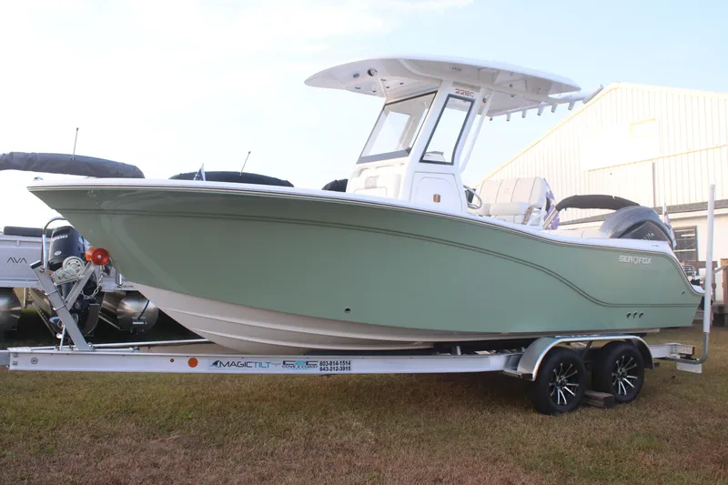 Slide: The Image of 2026 Sea Fox 228 Commander boat on trailer, displayed outdoors. - 3
