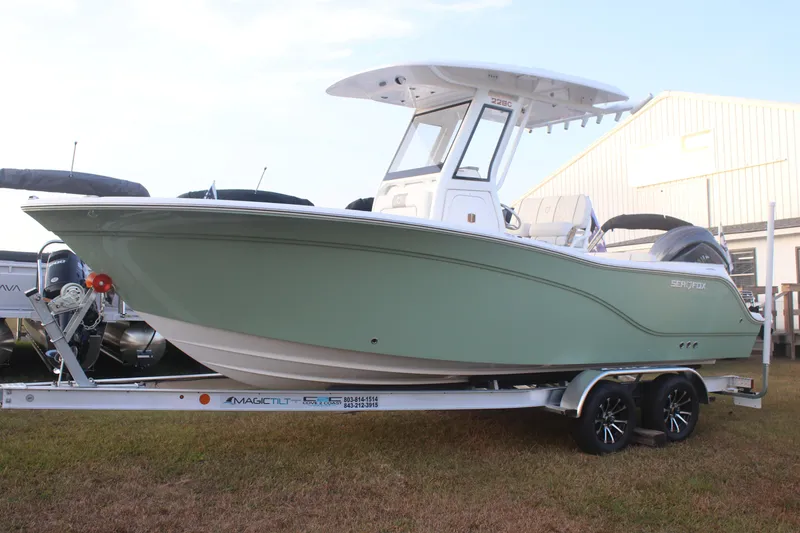 Slide: The Image of 2026 Sea Fox 228 Commander boat on trailer, side view, outdoors. - 4