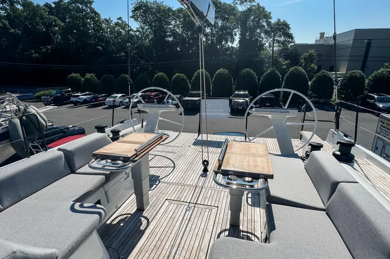Slide: The Image of Luxurious 2024 Beneteau First 53 yacht deck with dual steering wheels and seating area. - 14
