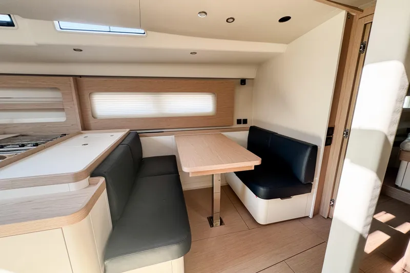 Slide: The Image of 2024 Beneteau First 53 yacht interior with modern dining area and sleek design. - 16