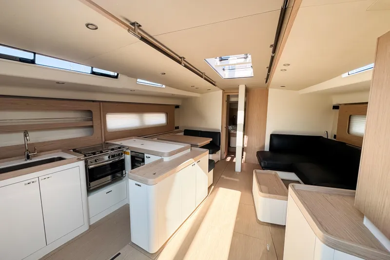 Slide: The Image of Luxurious interior of 2024 Beneteau First 53 yacht, featuring modern kitchen and seating area. - 18