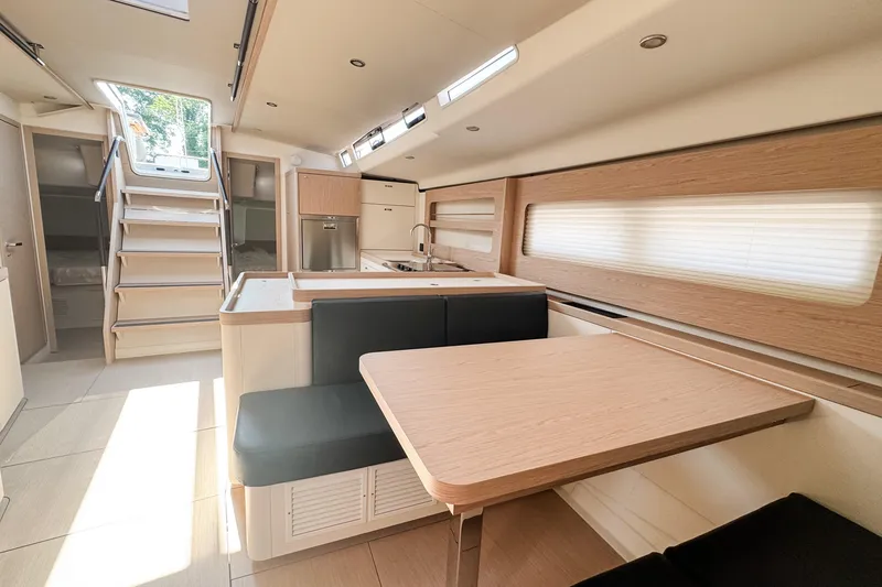 Slide: The Image of Luxurious interior of 2024 Beneteau First 53 yacht, featuring modern kitchen and dining area. - 21