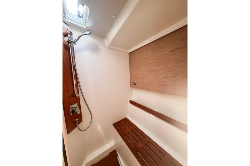Slide: The Image of 2024 Beneteau First 53 yacht shower with wooden accents and modern fixtures. - 23
