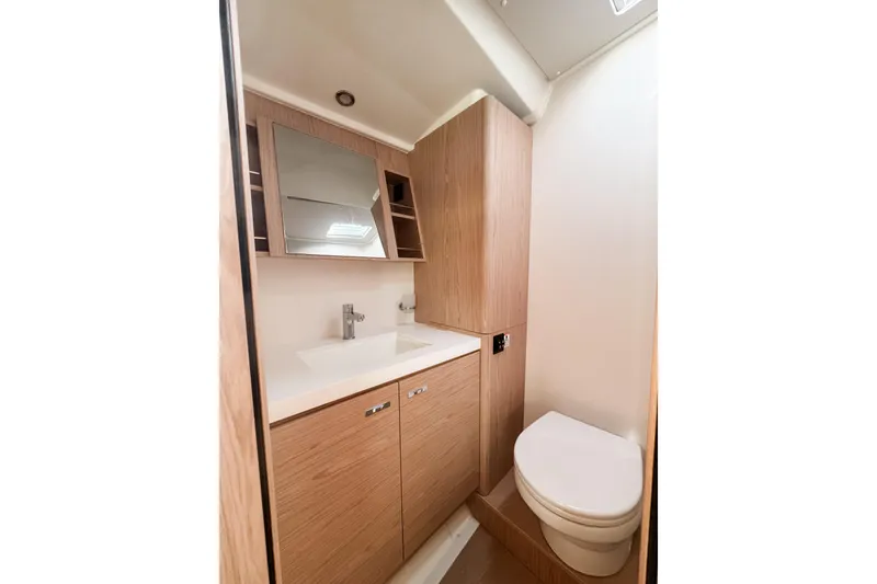 Slide: The Image of Modern bathroom in 2024 Beneteau First 53 yacht with wood cabinetry and sleek fixtures. - 24