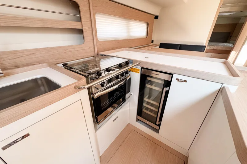 Slide: The Image of Modern kitchen interior of 2024 Beneteau First 53 yacht with stove and wine cooler. - 26