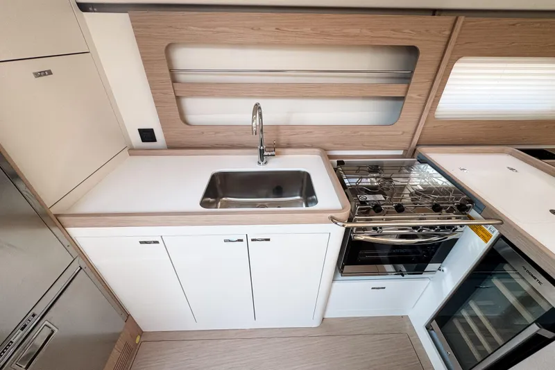 Slide: The Image of Modern kitchen in 2024 Beneteau First 53 yacht with sleek design and stainless steel appliances. - 27