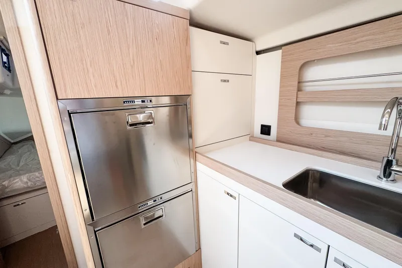 Slide: The Image of Modern kitchen in 2024 Beneteau First 53 yacht with stainless steel appliances and sleek cabinetry. - 28