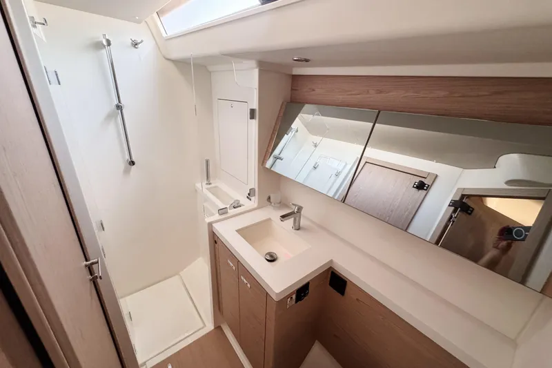Slide: The Image of Luxurious bathroom in 2024 Beneteau First 53 yacht, featuring modern fixtures and wood accents. - 30