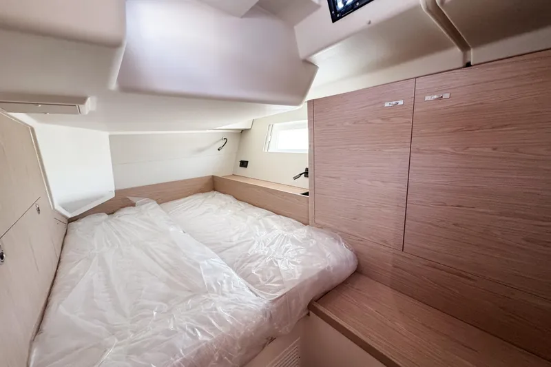 Slide: The Image of Luxurious cabin interior of 2024 Beneteau First 53 yacht, featuring modern wood finishes. - 31