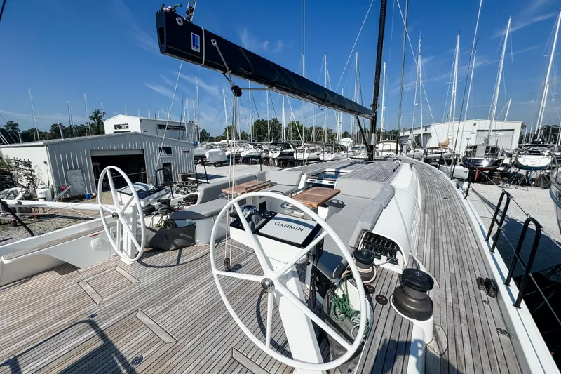 Slide: The Image of 2024 Beneteau First 53 yacht deck with dual steering wheels and modern navigation equipment. - 4