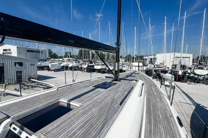 Slide: The Image of 2024 Beneteau First 53 yacht in marina, showcasing sleek deck design and mast. - 8
