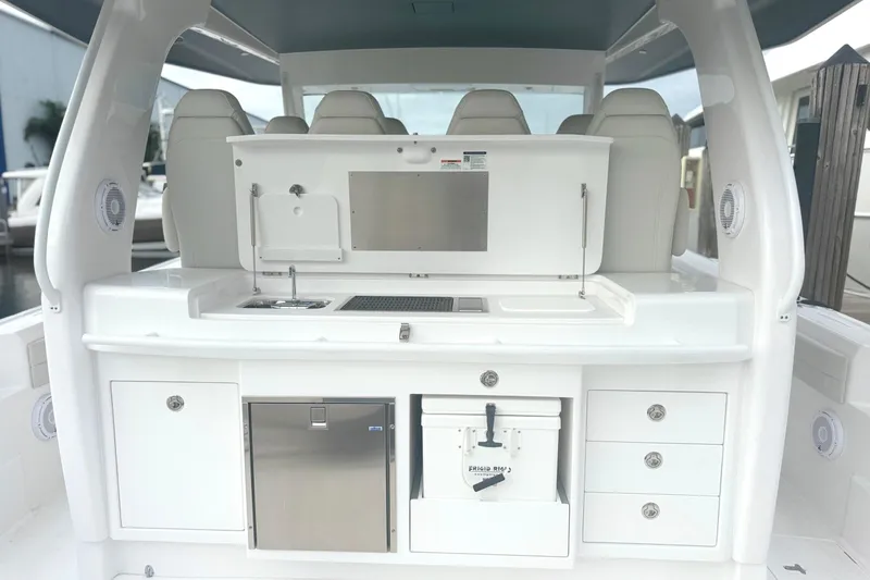 Slide: The Image of 2025 Intrepid 51 Panacea boat interior with sleek white cabinetry and modern amenities. - 5