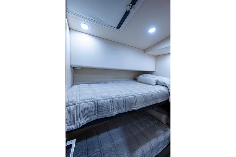 Slide: The Image of Luxurious cabin interior of 2018 Maritimo M54 yacht with cozy bed and elegant wood finish. - 56