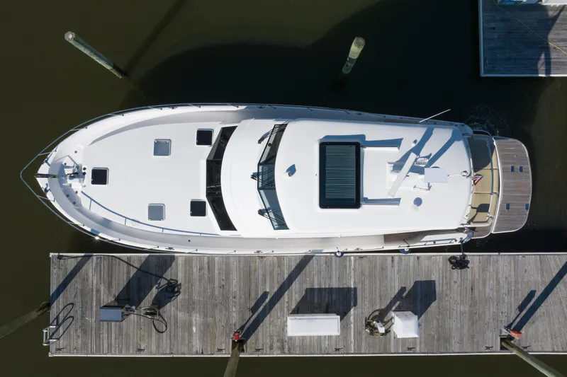 Slide: The Image of Overhead view of a 2018 Maritimo M54 yacht docked at a marina. - 90