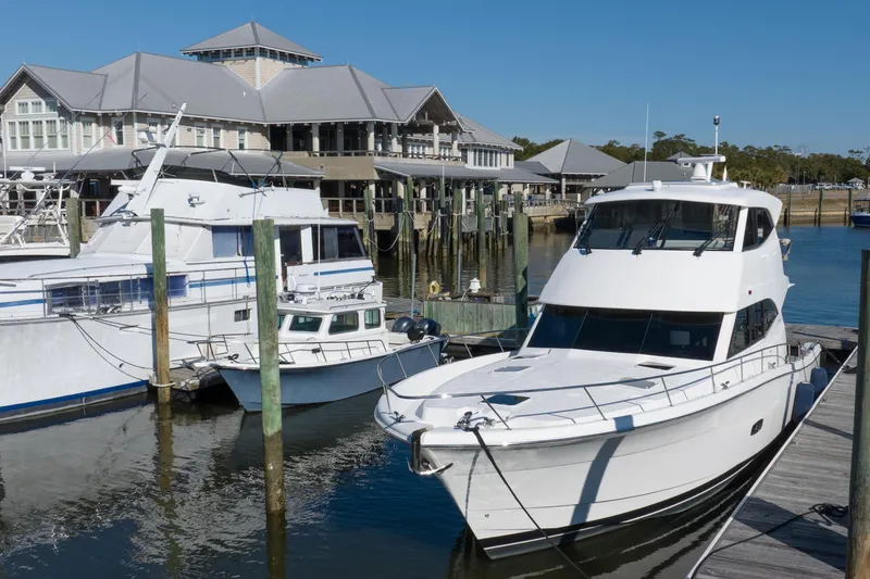 Slide: The Image of 2018 Maritimo M54 yacht docked at a marina with other boats. - 92
