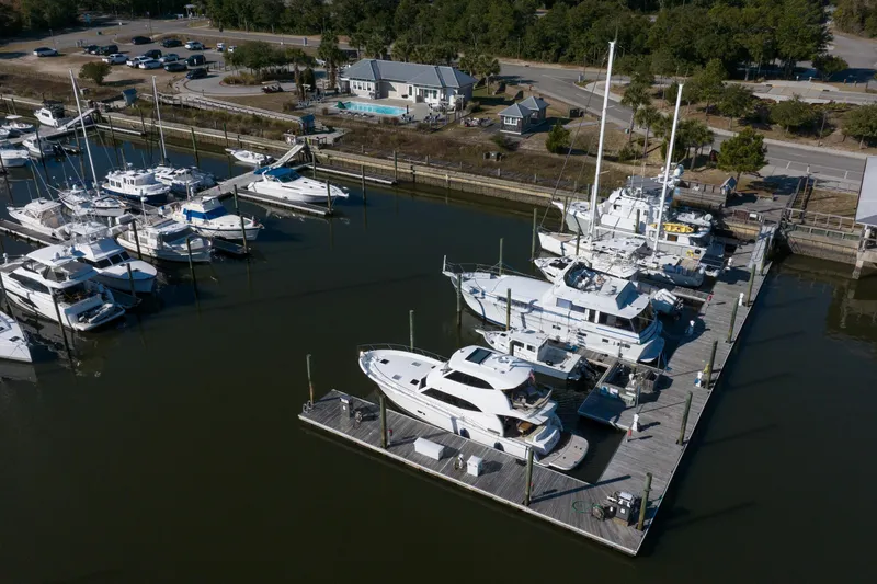 Slide: The Image of Aerial view of a marina featuring a 2018 Maritimo M54 yacht docked among other boats. - 94