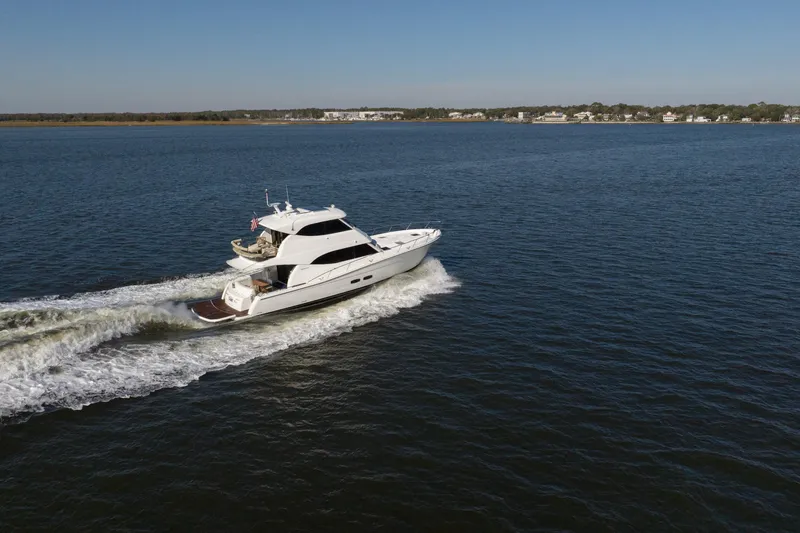 Slide: The Image of 2018 Maritimo M54 yacht cruising on open water under clear blue sky. - 95