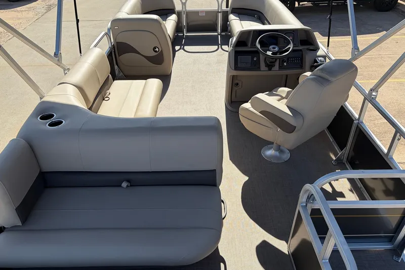 Slide: The Image of 2024 Sun Tracker Party Barge 18 DLX interior with seating and steering console. - 11