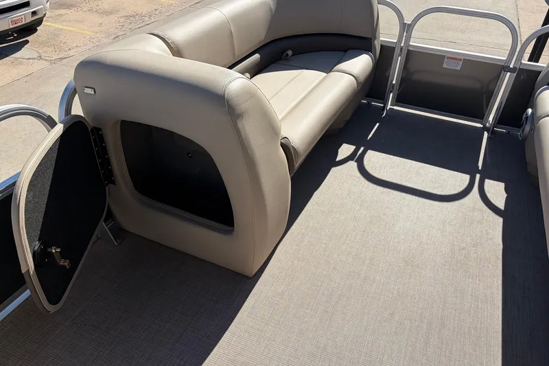 Slide: The Image of 2024 Sun Tracker Party Barge 18 DLX interior with seating and storage compartment. - 14