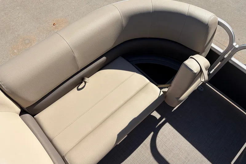 Slide: The Image of 2024 Sun Tracker Party Barge 18 DLX, beige seating, curved design, outdoor setting. - 16