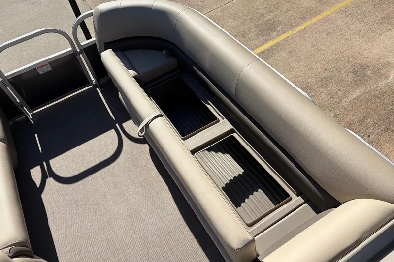 Slide: The Image of 2024 Sun Tracker Party Barge 18 DLX interior with seating and storage compartments. - 19