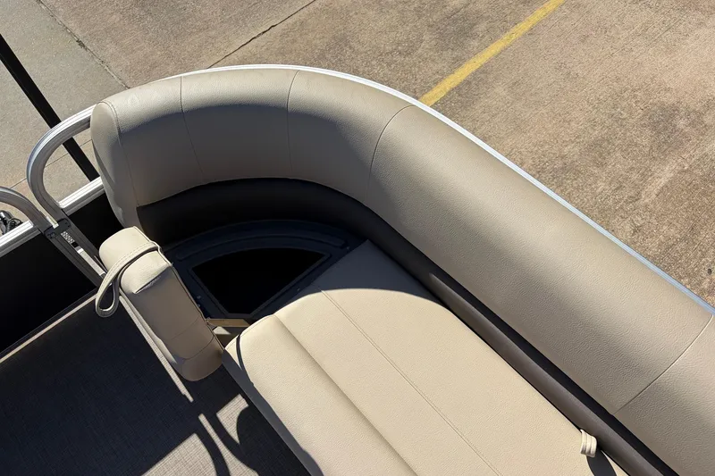 Slide: The Image of 2024 Sun Tracker Party Barge 18 DLX, beige seating detail, outdoor setting. - 20