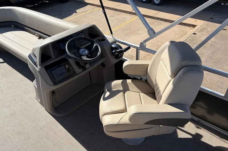 Slide: The Image of 2024 Sun Tracker Party Barge 18 DLX interior with steering console and comfortable seating. - 26