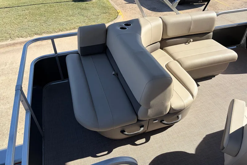 Slide: The Image of 2024 Sun Tracker Party Barge 18 DLX with beige seating and cup holders. - 31