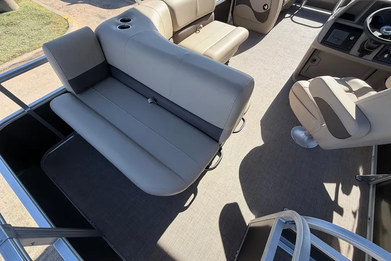 Slide: The Image of 2024 Sun Tracker Party Barge 18 DLX interior with seating and steering console. - 32