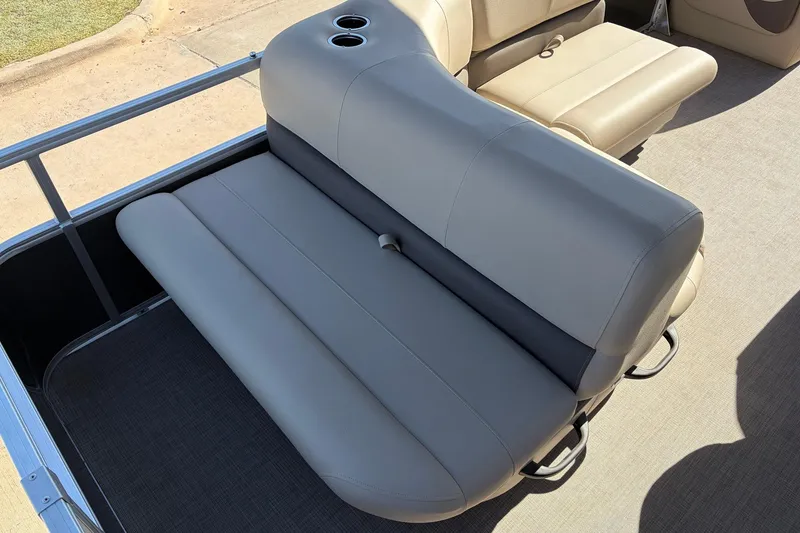 Slide: The Image of 2024 Sun Tracker Party Barge 18 DLX seating area with cup holders and beige upholstery. - 33