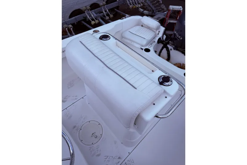 Slide: The Image of 2004 Boston Whaler 190 Nantucket boat interior with white seating and steering wheel. - 13