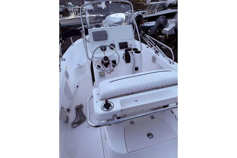 Slide: The Image of 2004 Boston Whaler 190 Nantucket boat interior with steering wheel and controls. - 14
