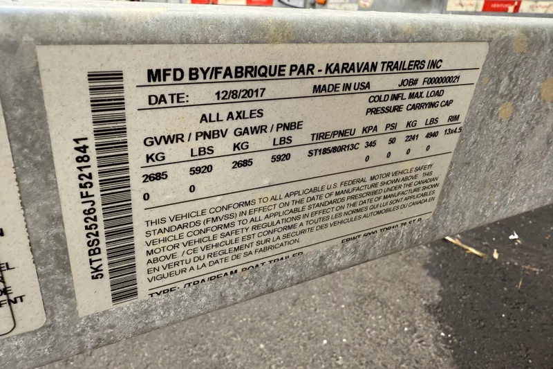 Slide: The Image of Label on a Karavan trailer, manufactured 12/8/2017, showing weight and tire specifications. - 24