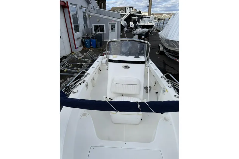 Slide: The Image of 2004 Boston Whaler 190 Nantucket boat docked, showcasing spacious interior and console. - 7
