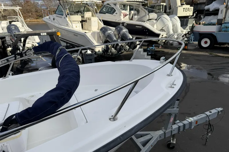 Slide: The Image of 2004 Boston Whaler 190 Nantucket boat on trailer, surrounded by other boats. - 8