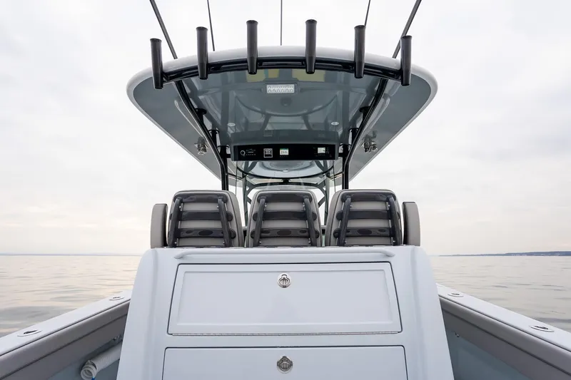 Slide: The Image of 2023 Valhalla Boatworks V-33 center console with seating and rod holders on calm water. - 15