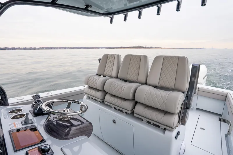 Slide: The Image of 2023 Valhalla Boatworks V-33 interior with luxurious seating and modern helm controls. - 16