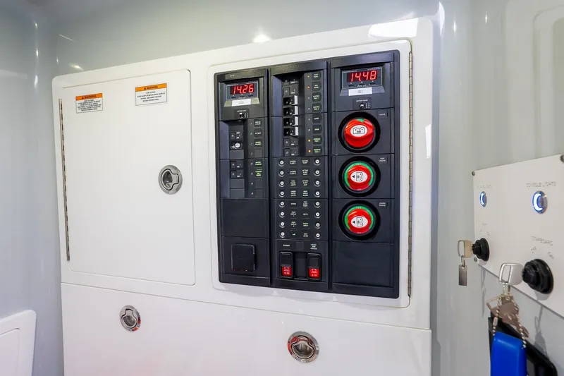 Slide: The Image of Electrical panel of 2023 Valhalla Boatworks V-33, featuring control switches and digital displays. - 28