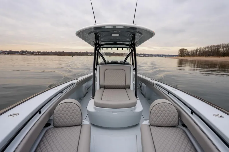 Slide: The Image of 2023 Valhalla Boatworks V-33 on calm water, featuring luxurious seating and sleek design. - 30