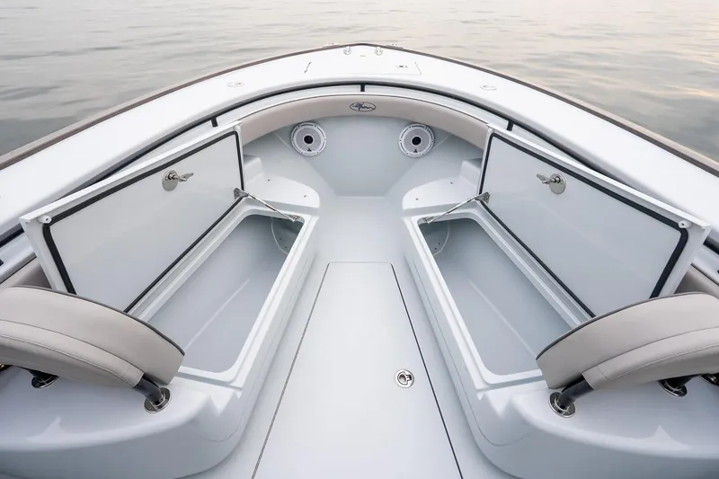 Slide: The Image of 2023 Valhalla Boatworks V-33 interior with open storage compartments on calm water. - 34