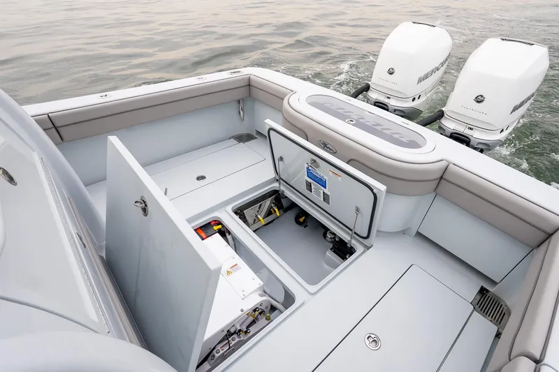 Slide: The Image of 2023 Valhalla Boatworks V-33 with open storage compartments and dual Mercury outboard engines. - 9