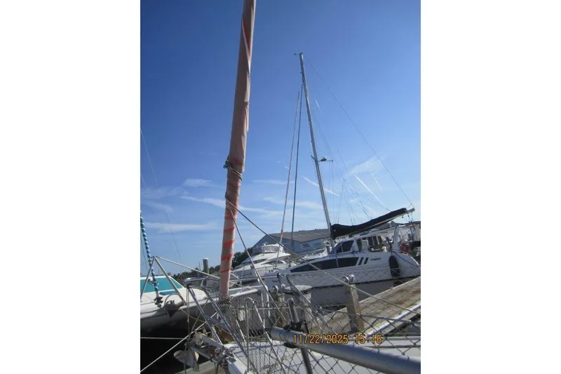 Slide: The Image of Sailboats docked under clear blue sky, featuring a 1986 Catalina 30 MkII. - 12