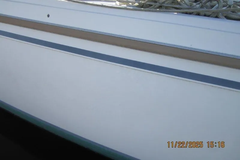 Slide: The Image of Side view of a 1986 Catalina 30 MkII sailboat with visible ropes. - 13