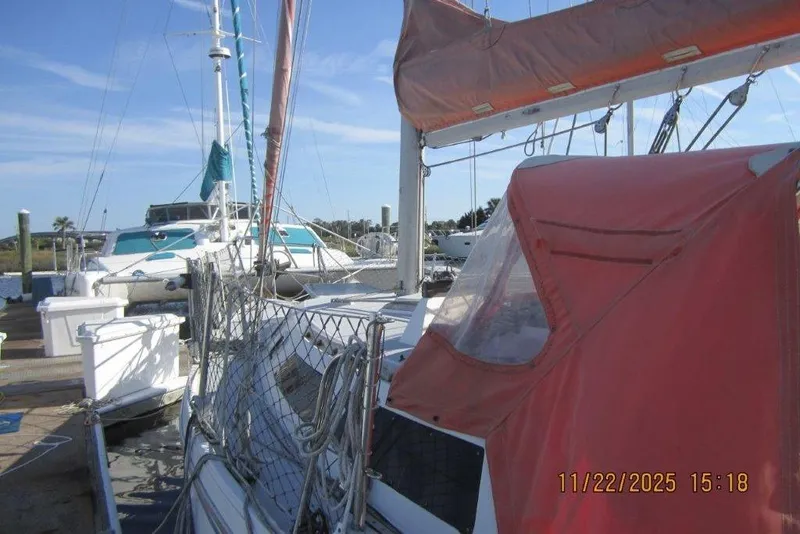 Slide: The Image of 1986 Catalina 30 MkII sailboat docked with orange canopy and clear sky. - 15