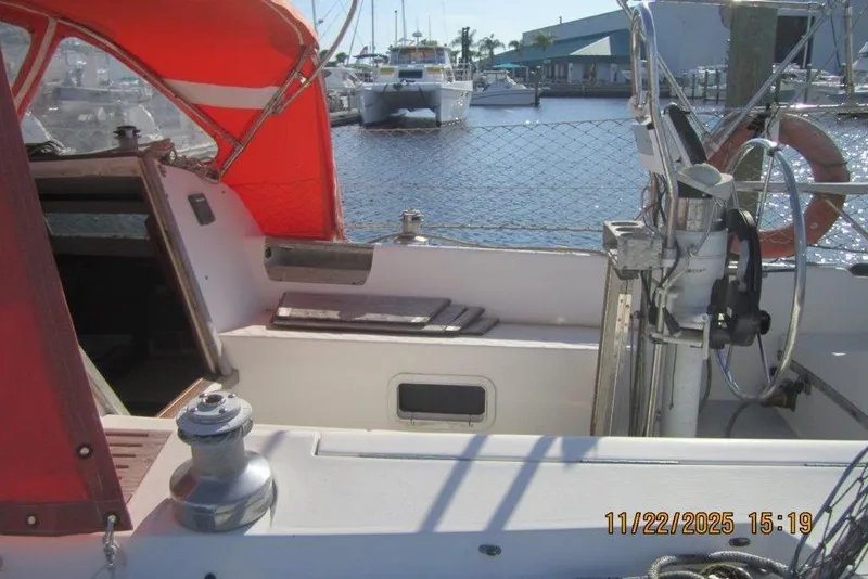 Slide: The Image of 1986 Catalina 30 MkII sailboat cockpit with red canopy, docked at marina. - 17